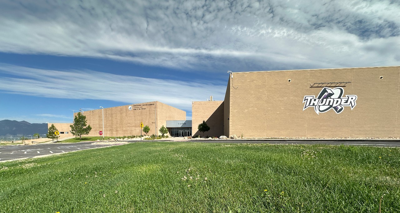 The DCCHS building surrounded by grass and sky.